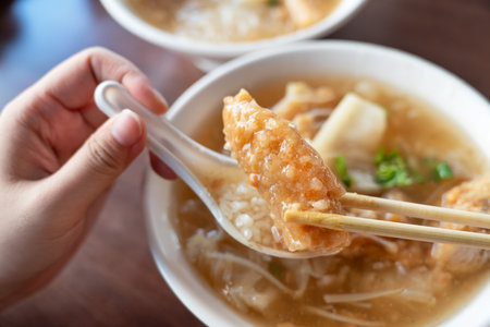 Delicious fried narrow-barred Spanish mackerel fish fillet with rice and noodles in thick soup in Tainan, Taiwan.の写真素材