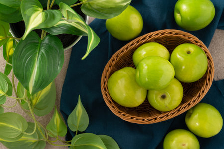 Fresh juicy delicious Taiwanese Milk Indian Jujube fruit in a basket on gray table background.の写真素材