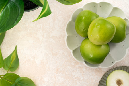 Fresh juicy delicious Taiwanese Milk Indian Jujube fruit in a basket on gray table background.