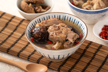 Delicious Taiwanese shiitake mushroom chicken soup in a bowl on white table background.の写真素材