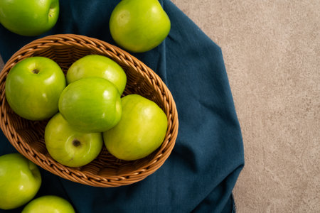 Fresh juicy delicious Taiwanese Milk Indian Jujube fruit in a basket on gray table background.の写真素材