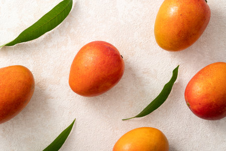 Fresh sliced, cut, diced ripe mango on gray table background with leaf for eating.