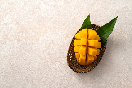 Fresh sliced, cut, diced ripe mango on gray table background with leaf for eating.の写真素材