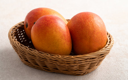 Fresh sliced, cut, diced ripe mango on gray table background with leaf for eating.の写真素材