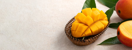 Fresh sliced, cut, diced ripe mango on gray table background with leaf for eating.の写真素材
