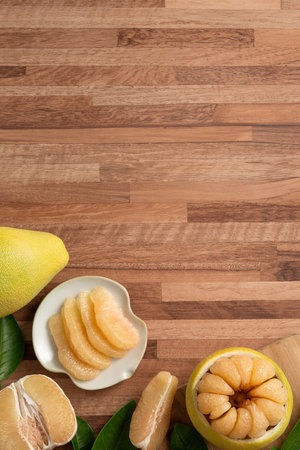 Fresh peeled pomelo with leaf on wooden table background for Mid-Autumn Festival fruit.