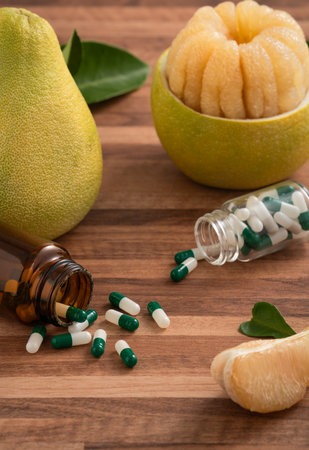 Fresh pomelo fruit with leaf and medicine adverse drug reaction interaction design concept.の写真素材
