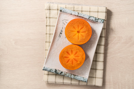 Fresh ripe sweet persimmon kaki fruit on wooden table background.の写真素材