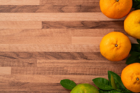 Fresh juice tangerine mandarin orange with leaf on wooden table background.の写真素材