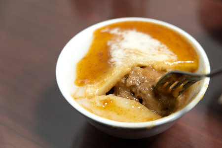 Taiwanese savory rice pudding, rice cake with soy sauce in a bowl.の写真素材
