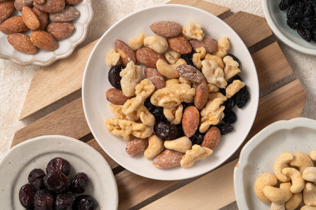 Flavored mixed nuts in bowls on white table background.の写真素材
