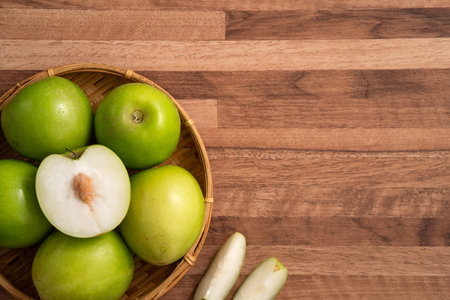 Fresh juicy delicious Taiwanese Milk Indian Jujube fruit in a basket on wooden table background.の写真素材
