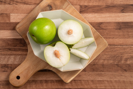 Fresh juicy delicious Milk Indian Jujube fruit in a basket on wooden table background.の写真素材