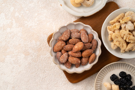 Flavored mixed nuts in bowls on white table background.の写真素材