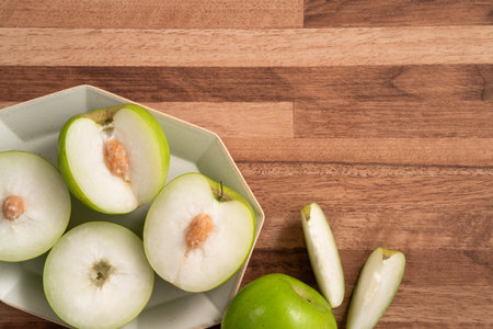 Fresh juicy delicious Milk Indian Jujube fruit in a basket on wooden table background.の写真素材