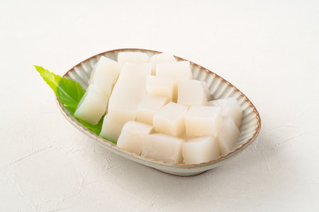 Raw konjac in square shape in a plate on white table background, also named konnyaku in Japan.の写真素材