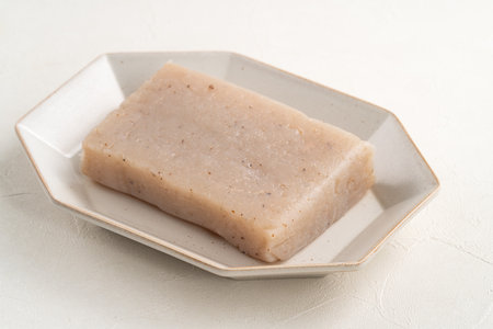 Raw konjac in square shape in a plate on white table background.の写真素材