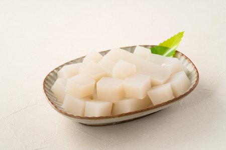 Raw konjac in square shape in a plate on white table background, also named konnyaku in Japan.の写真素材