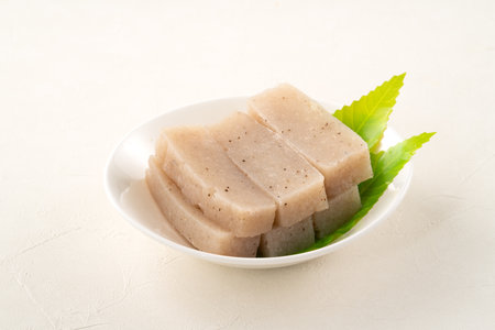 Raw konjac in square shape in a plate on white table background, also named konnyaku in Japan.の写真素材