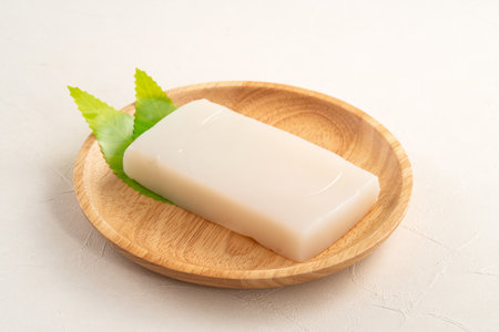 Raw konjac in square shape in a plate on white table background, also named konnyaku in Japan.の写真素材