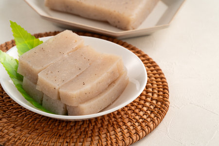 Raw konjac in square shape in a plate on white table background, also named konnyaku in Japan.の写真素材