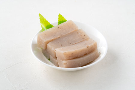 Raw konjac in square shape in a plate on white table background, also named konnyaku in Japan.の写真素材