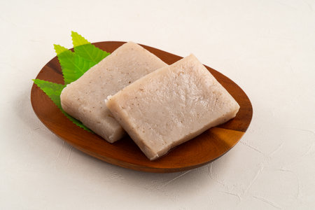 Raw konjac in square shape in a plate on white table background, also named konnyaku in Japan.の写真素材