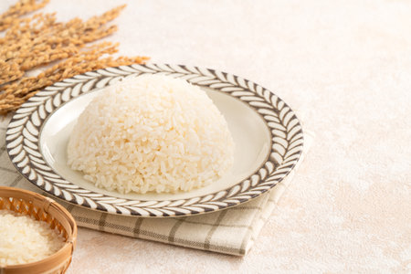 A bowl of freshly cooked steamed white rice, soft, fluffy, and slightly glossy on white table background.の写真素材