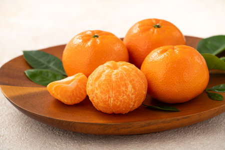 Fresh juice small tangerine mandarin orange in a plate on white table background.の写真素材