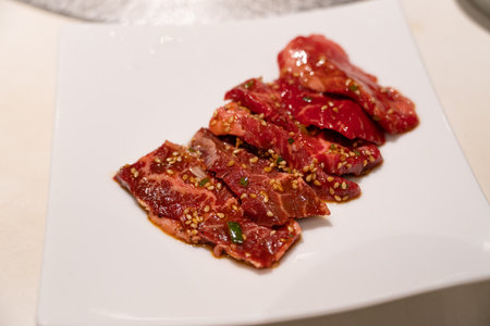 Marinated beef meat slices being grilled.の写真素材