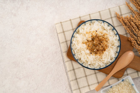 A bowl of fluffy white rice topped with sprinkle rice seasonings.の写真素材