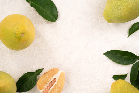 Fresh peeled pomelo with leaf on white table background for Mid-Autumn Festival fruit.の写真素材