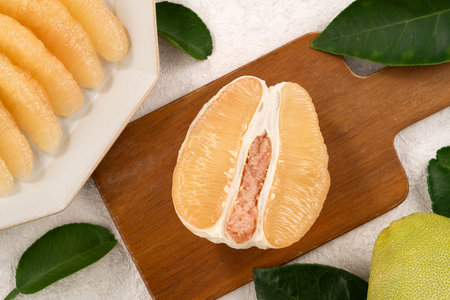Fresh peeled pomelo with leaf on white table background for Mid-Autumn Festival fruit.の写真素材