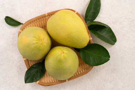 Fresh peeled pomelo with leaf on white table background for Mid-Autumn Festival fruit.の写真素材