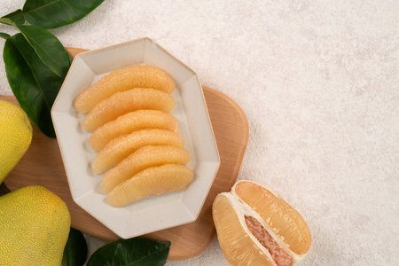 Fresh peeled pomelo with leaf on white table background for Mid-Autumn Festival fruit.の写真素材
