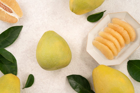 Fresh peeled pomelo with leaf on white table background for Mid-Autumn Festival fruit.の写真素材