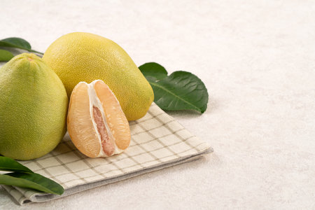 Fresh peeled pomelo with leaf on white table background for Mid-Autumn Festival fruit.の写真素材