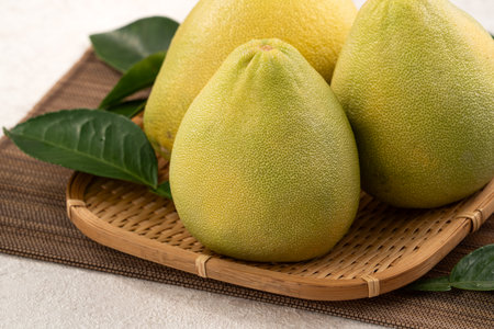 Fresh peeled pomelo with leaf on white table background.の写真素材