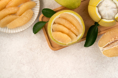 Fresh peeled pomelo with leaf on white table background for Mid-Autumn Festival fruit.の写真素材