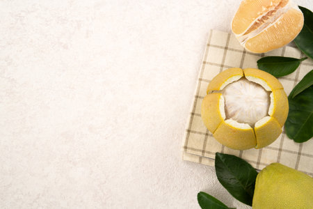 Fresh peeled pomelo with leaf on white table background for Mid-Autumn Festival fruit.の写真素材