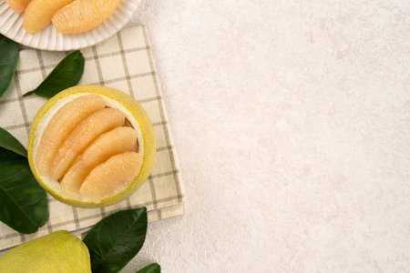 Fresh peeled pomelo with leaf on white table background for Mid-Autumn Festival fruit.