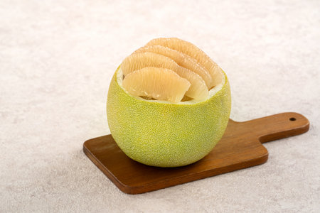 Fresh peeled pomelo with leaf on white table background for Mid-Autumn Festival fruit.の写真素材