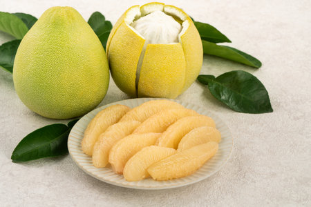 Fresh peeled pomelo with leaf on white table background for Mid-Autumn Festival fruit.の写真素材
