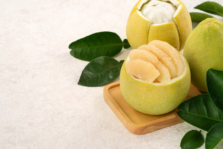 Fresh peeled pomelo with leaf on white table background for Mid-Autumn Festival fruit.の写真素材
