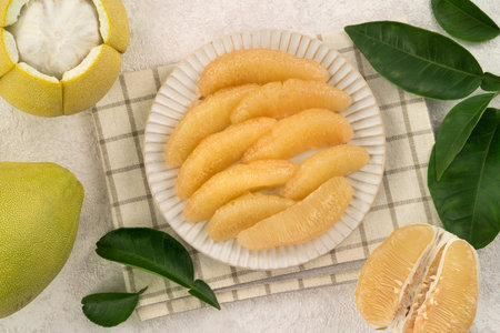 Fresh peeled pomelo with leaf on white table background for Mid-Autumn Festival fruit.の写真素材