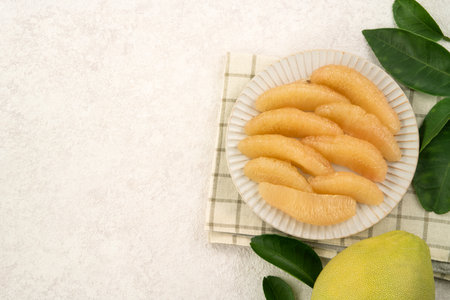 Fresh peeled pomelo with leaf on white table background for Mid-Autumn Festival fruit.の写真素材