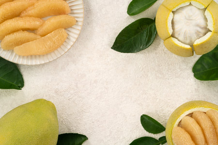Fresh peeled pomelo with leaf on white table background for Mid-Autumn Festival fruit.の写真素材