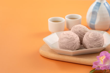 Taro puff pastries for Mid Autumn Festival holiday afternoon tea on orange table background.の写真素材