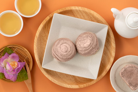 Taro puff pastries for Mid Autumn Festival holiday afternoon tea on orange table background.の写真素材