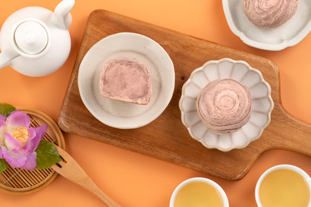 Taro puff pastries for Mid Autumn Festival holiday afternoon tea on orange table background.の写真素材